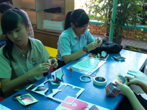 Children doing their own biting paper monster