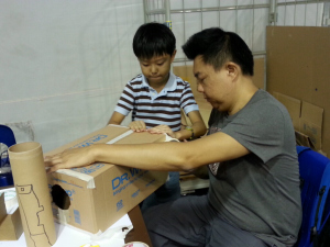 Father and Son thinking of ways to Make a different Vortex Cannon.